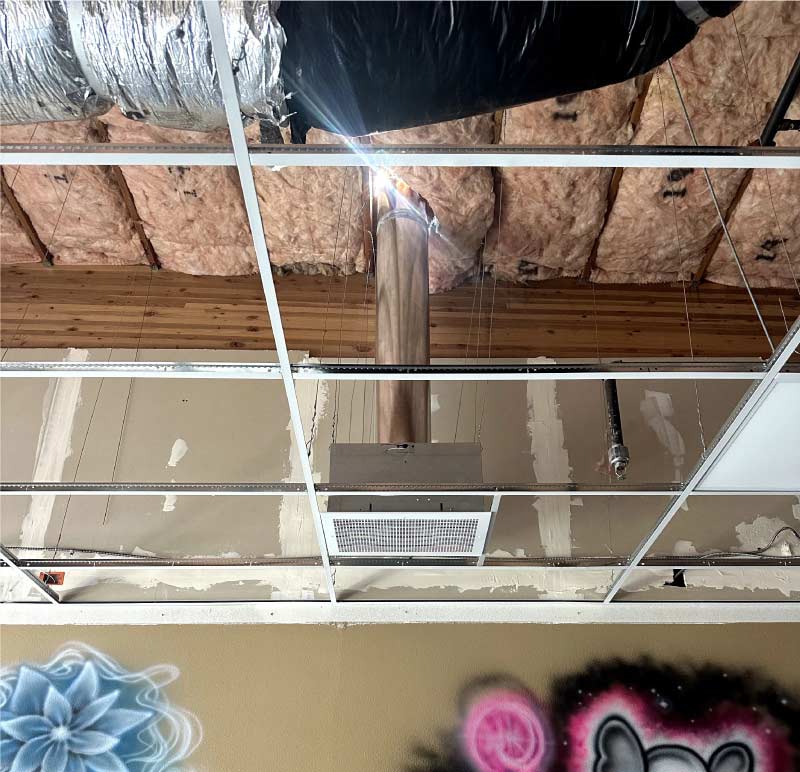 Custom ductwork being fitted in the attic of a new construction home in Clovis, California