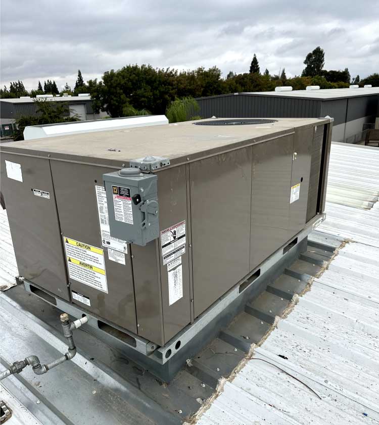 HVAC technicians to perform coil cleaning on a residential air conditioning unit in Fresno, CA