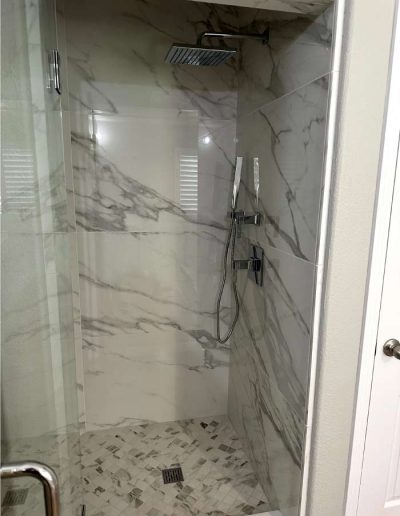 Modern walk-in shower with sleek fixtures and efficient water drainage system