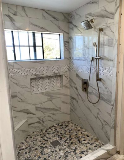 Elegant bathroom featuring a frameless glass shower and concealed plumbing solutions
